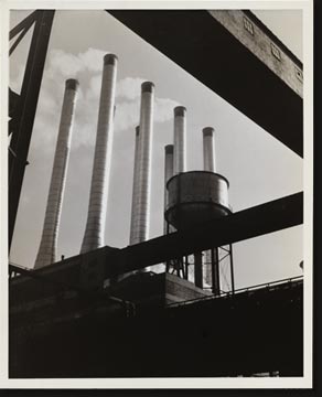 The conveyors at the Rouge plant of the Ford Motor Company were used by the photographer here to form an unusual geometric frame for the eight huge smokestacks at the plant.