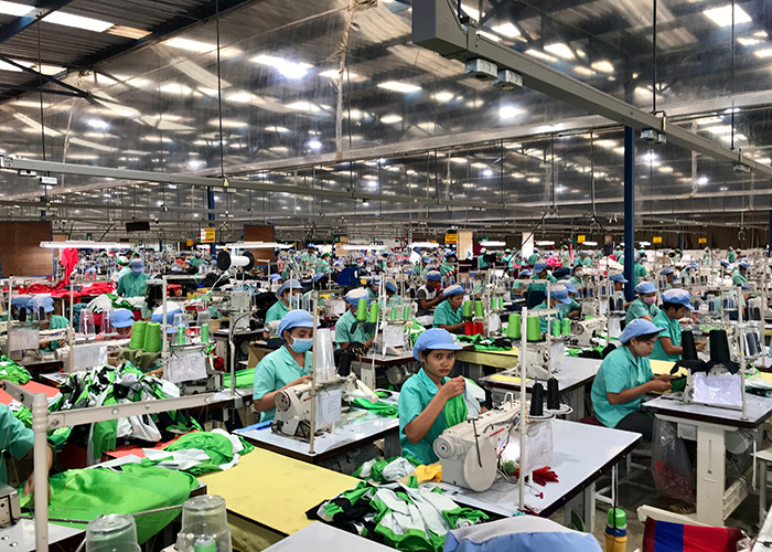 Labor worker producing clothes in garment factory. (Shutterstock)