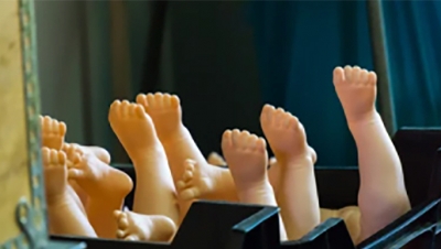 A box of new doll legs at a toy factory. (Shutterstock)