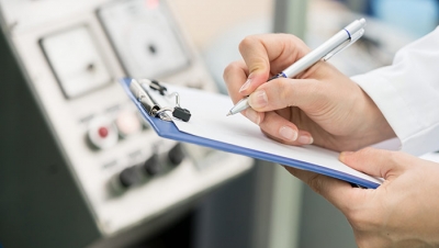 Image of an engineer writing a technical report. (Shutterstock)