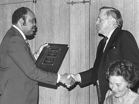 Black Alumni Association President Walter L. Ross presents former HBS Dean George P. Baker with the Distinguished Service Award, 1979. HBS Archives Photograph Collection: Subject Files & Events. Baker Library, Harvard Business School.