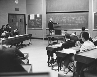Georges F. Doriot in classroom, 1963. HBS Archives Photograph Collection: Faculty and Staff. HBS Archives, Baker Library, Harvard Business School. olvwork377922