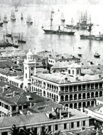 Pedder Street Clock Tower and Hongkong Hotel, Central District. Victoria Harbour in the background. The University of Hong Kong Libraries.