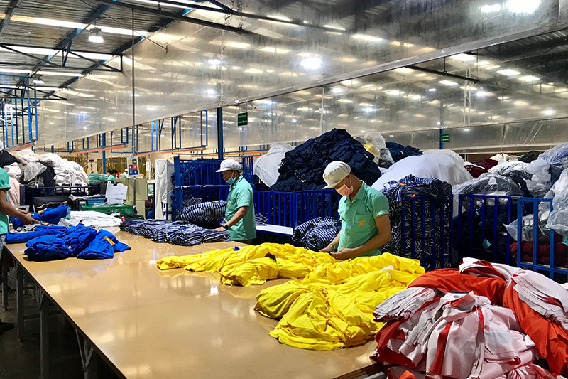 Labor worker producing clothes in garment factory. (Shutterstock)