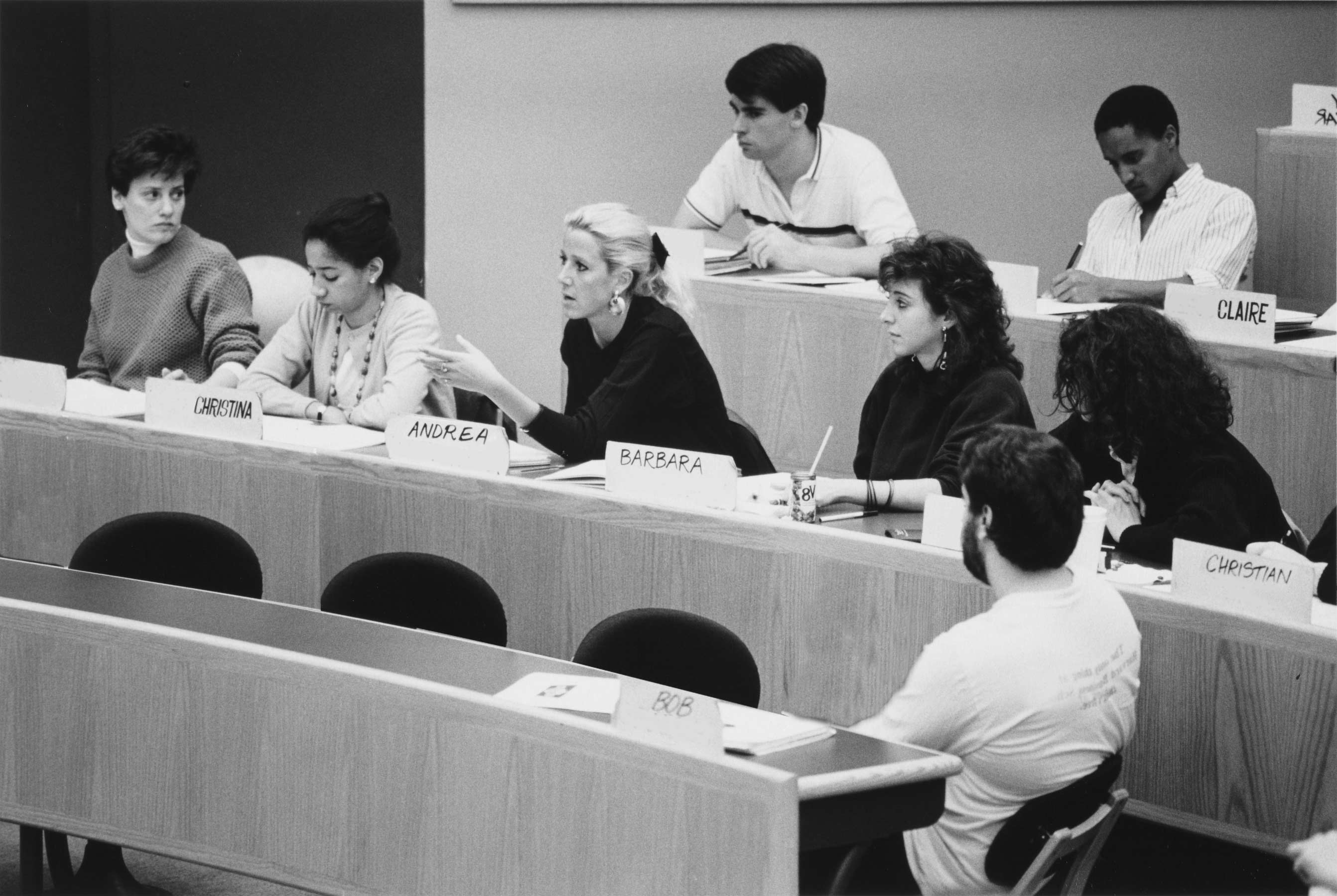 Black and white photograph of students in classroom discussing a case.