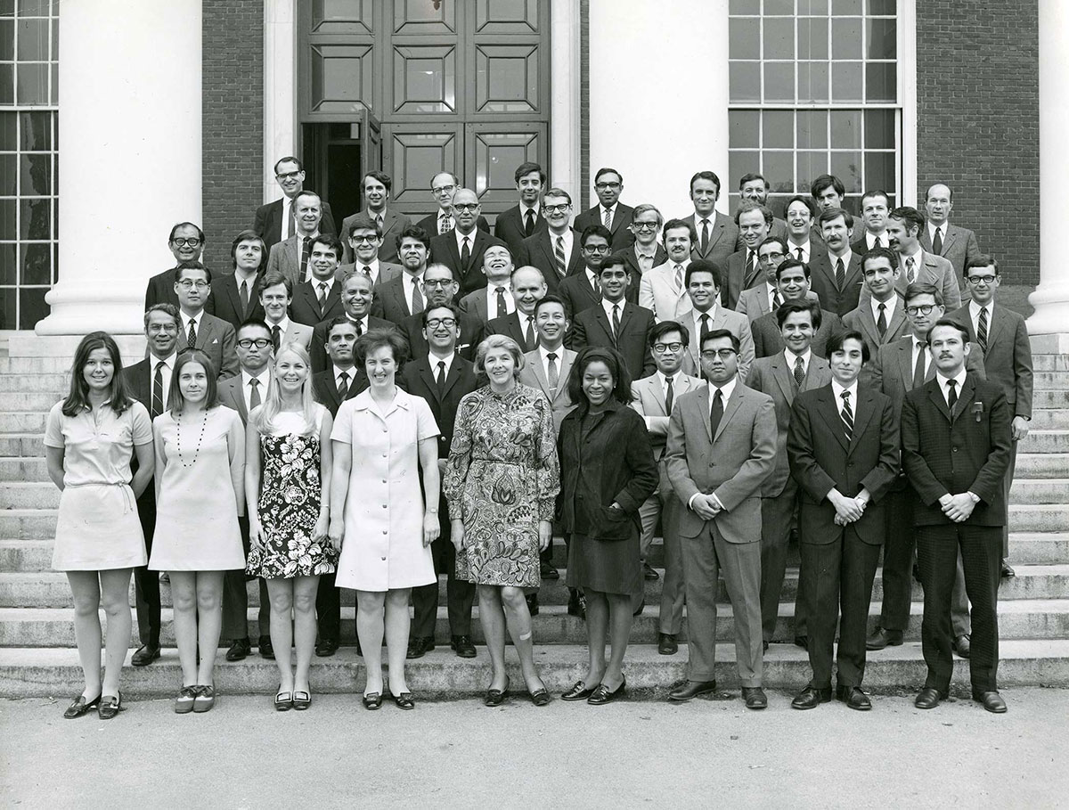 Group of male and female International Teachers Program students posing on the steps of Baker Library.