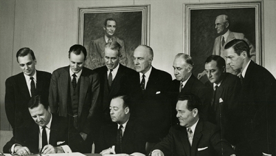Group of 10 men, including John C. Whitehead, gathered for the signing of the Ford Motor Co. initial public offering, 1956